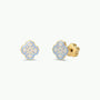The JaxKelly Snowflake Enamel Flat Back Kids Earrings are a pair of gold stud earrings shaped like snowflakes, featuring white and light purple enamel accents. Designed to be hypoallergenic for sensitive ears, they are shown on a plain white background.