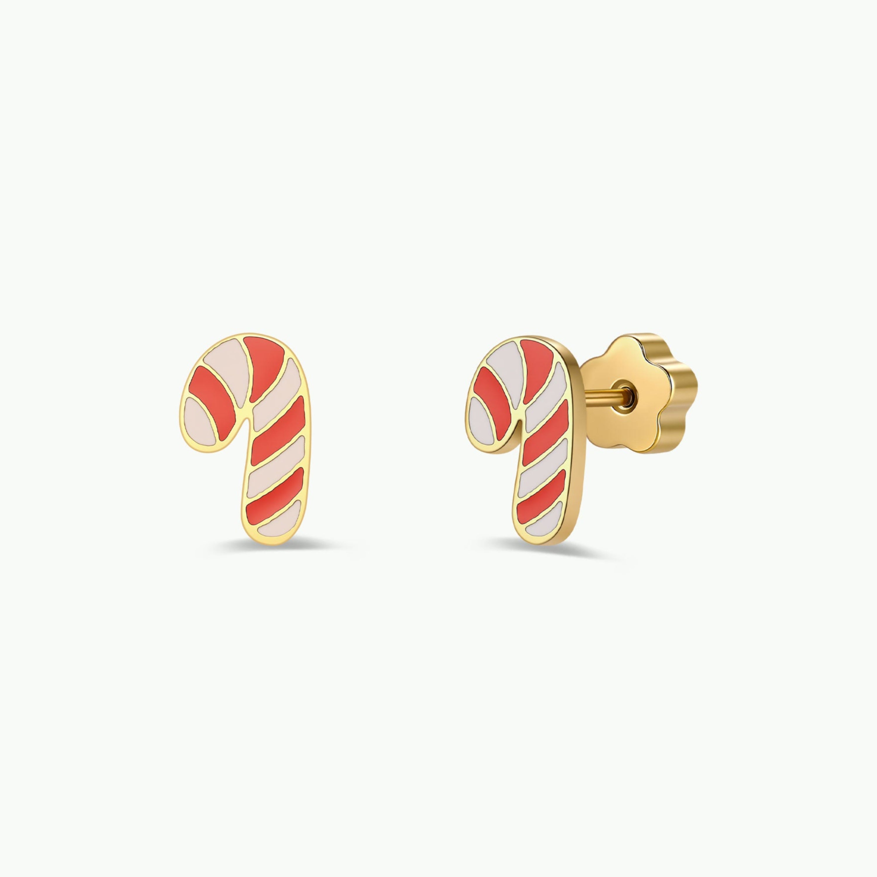 JaxKelly Candy Cane Enamel Flat Back Kids Earrings feature gold stud earrings shaped like candy canes with red, pink, and white enamel stripes. Designed with flower-shaped backings and hypoallergenic, surgical-grade stainless steel posts for comfortable everyday wear, these earrings are perfect for kids. The product is displayed against a plain white background.