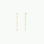 The Gemstone Chain Drop - White Opal earrings feature 18k gold plating and delicate chains adorned with evenly spaced white opal gems, elegantly displayed on a plain light background.