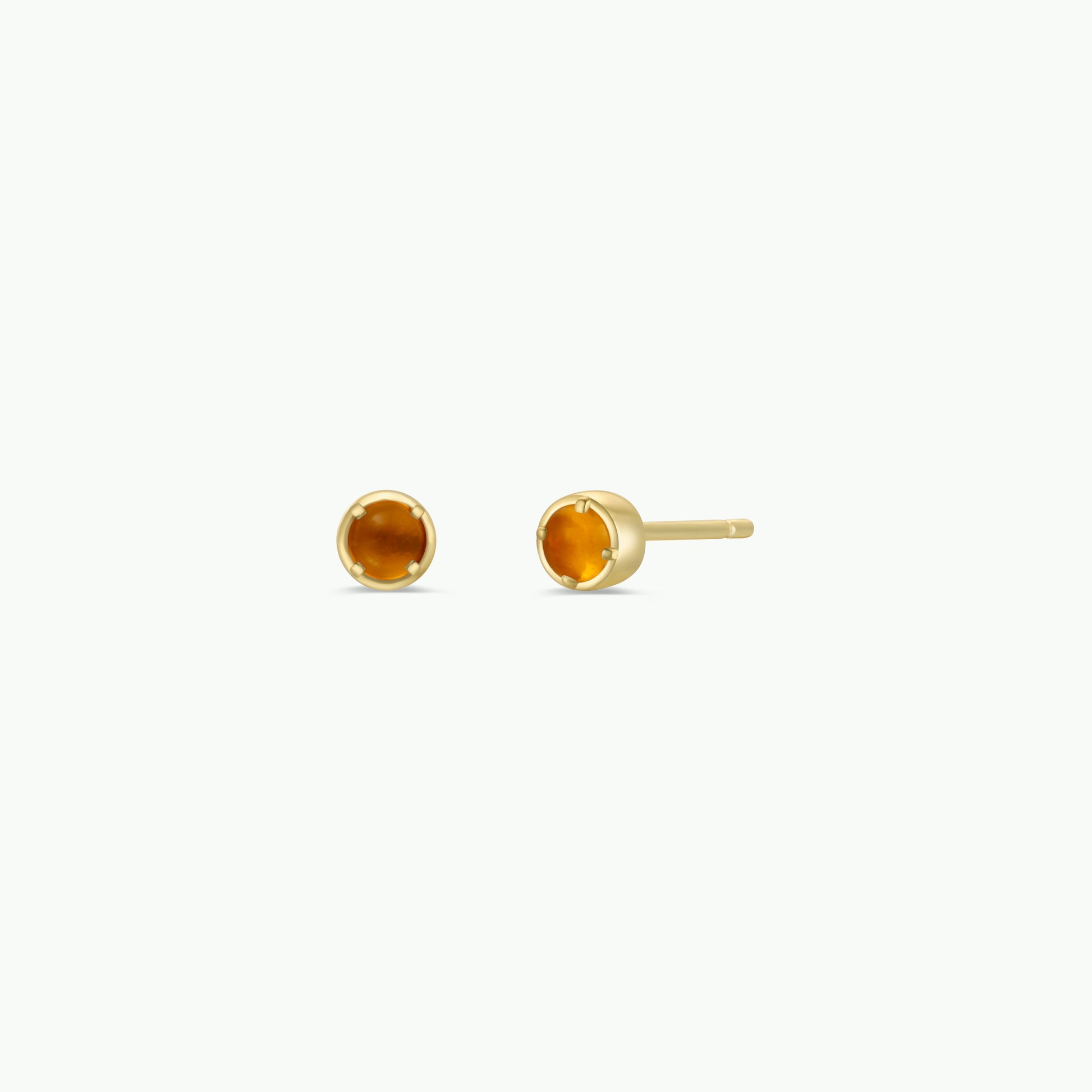 The JaxKelly Simple Stud Earring features small, round amber gemstones in gold-plated bezel settings with sterling silver posts, shown against a plain white background.
