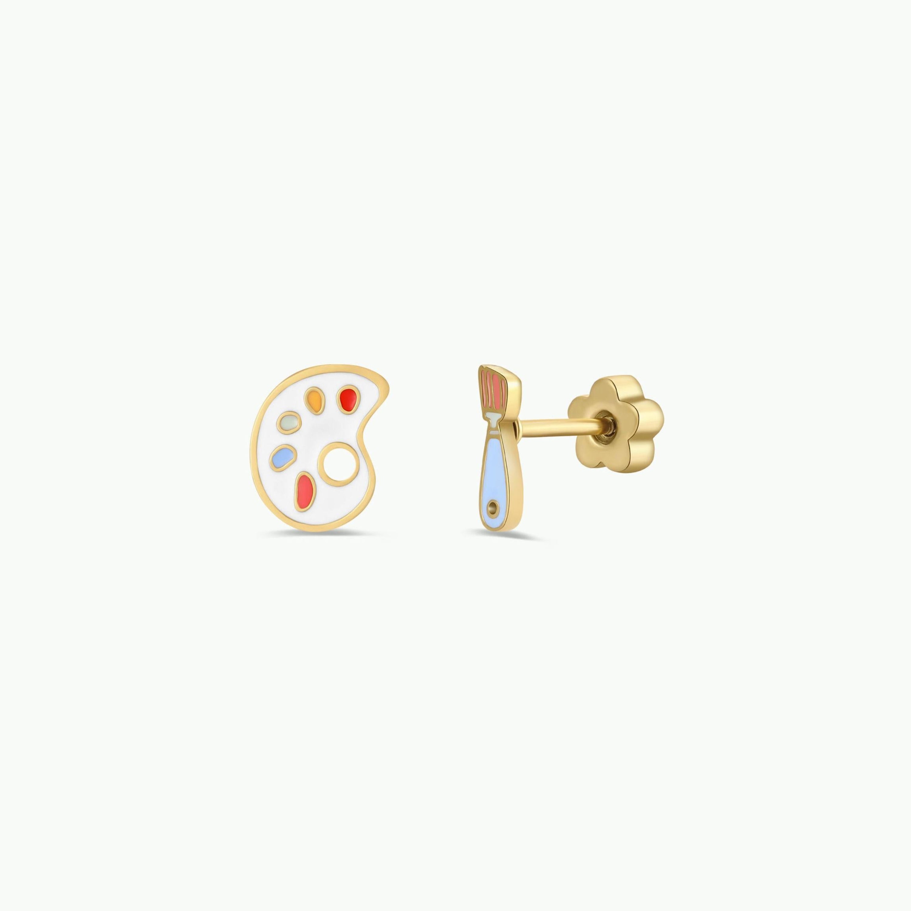 The Artist Palette Enamel Flat Back Kids Earrings feature hypoallergenic gold studs for sensitive ears—one shaped like a colorful paint palette, the other a pastel paintbrush. Perfect for kids, pictured on a plain white background.