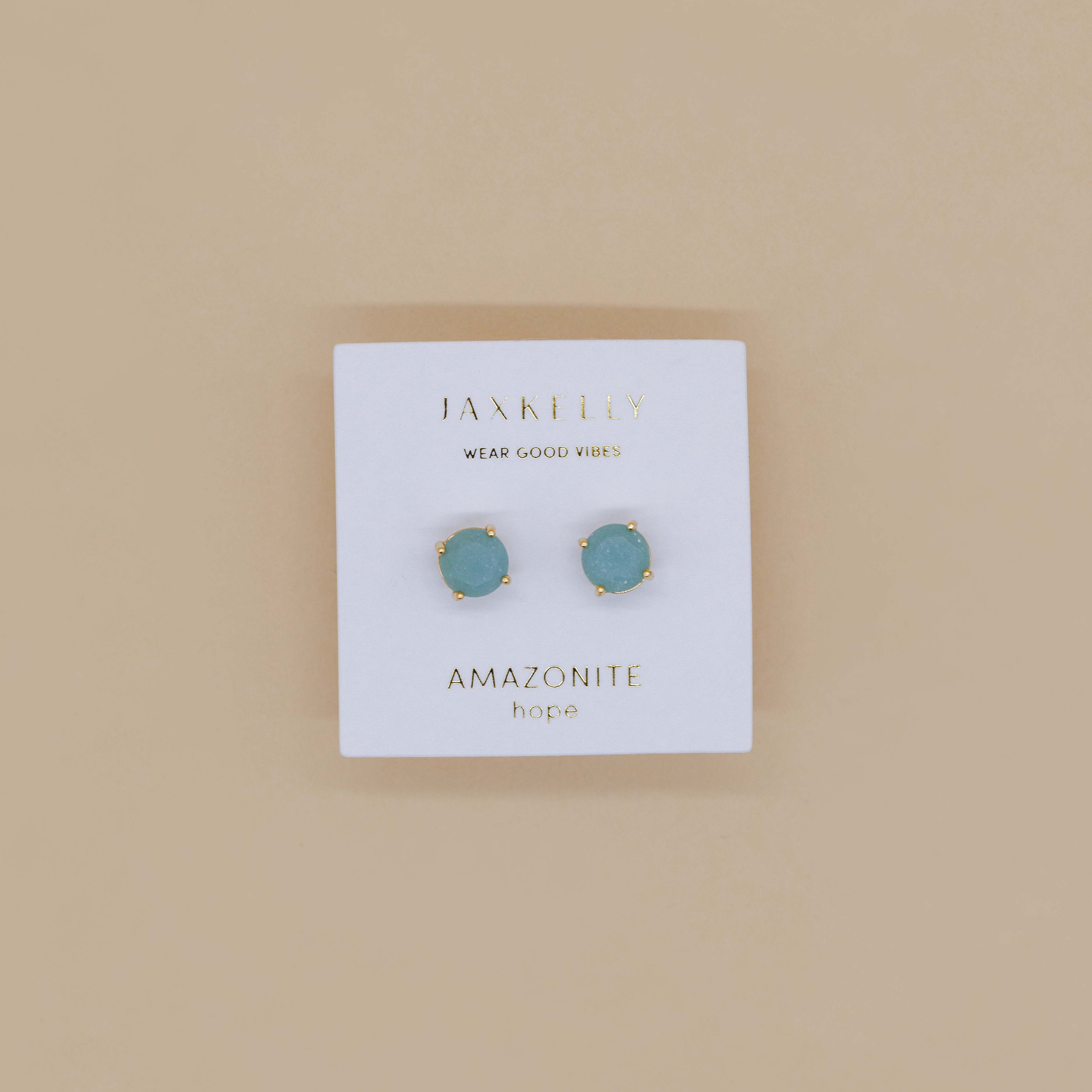 The Round - Amazonite Gemstone - Gold Earrings are shown on a white JaxKelly card labeled "Wear Good Vibes" and "Amazonite hope," set against a beige background.