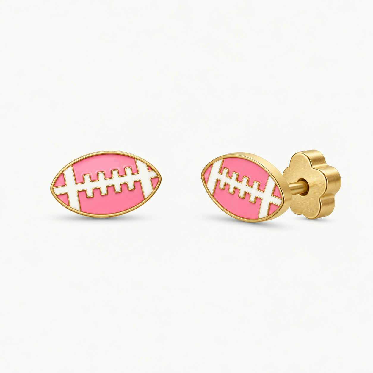 JaxKelly Football Enamel Flat Back Kids Earrings: hypoallergenic gold stud earrings shaped like footballs with pink and white enamel details and flower-shaped backings.