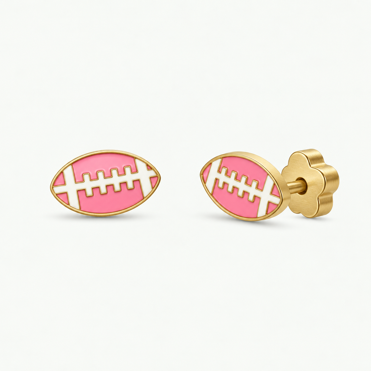 JaxKelly Football Enamel Flat Back Kids Earrings: hypoallergenic gold stud earrings shaped like footballs with pink and white enamel details and flower-shaped backings.