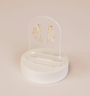 Gold, fan-shaped earrings with sparkling stones are displayed on the Clear Earring Display Arch Solid, featuring a clear acrylic stand with a round white base, all set against a light beige backdrop for an elegant retail look.