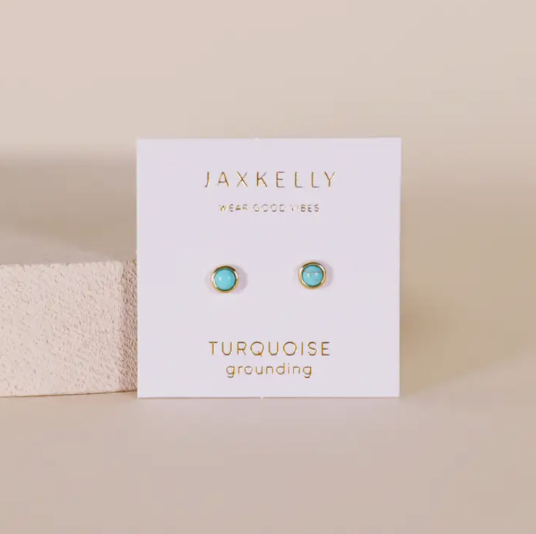 A pair of Simple Stud Earring - Turquoise Gemstone by JaxKelly, hypoallergenic and displayed on a white card with gold “JaxKelly,” “Wear Good Vibes,” and “Turquoise grounding” lettering, shown against a neutral background.