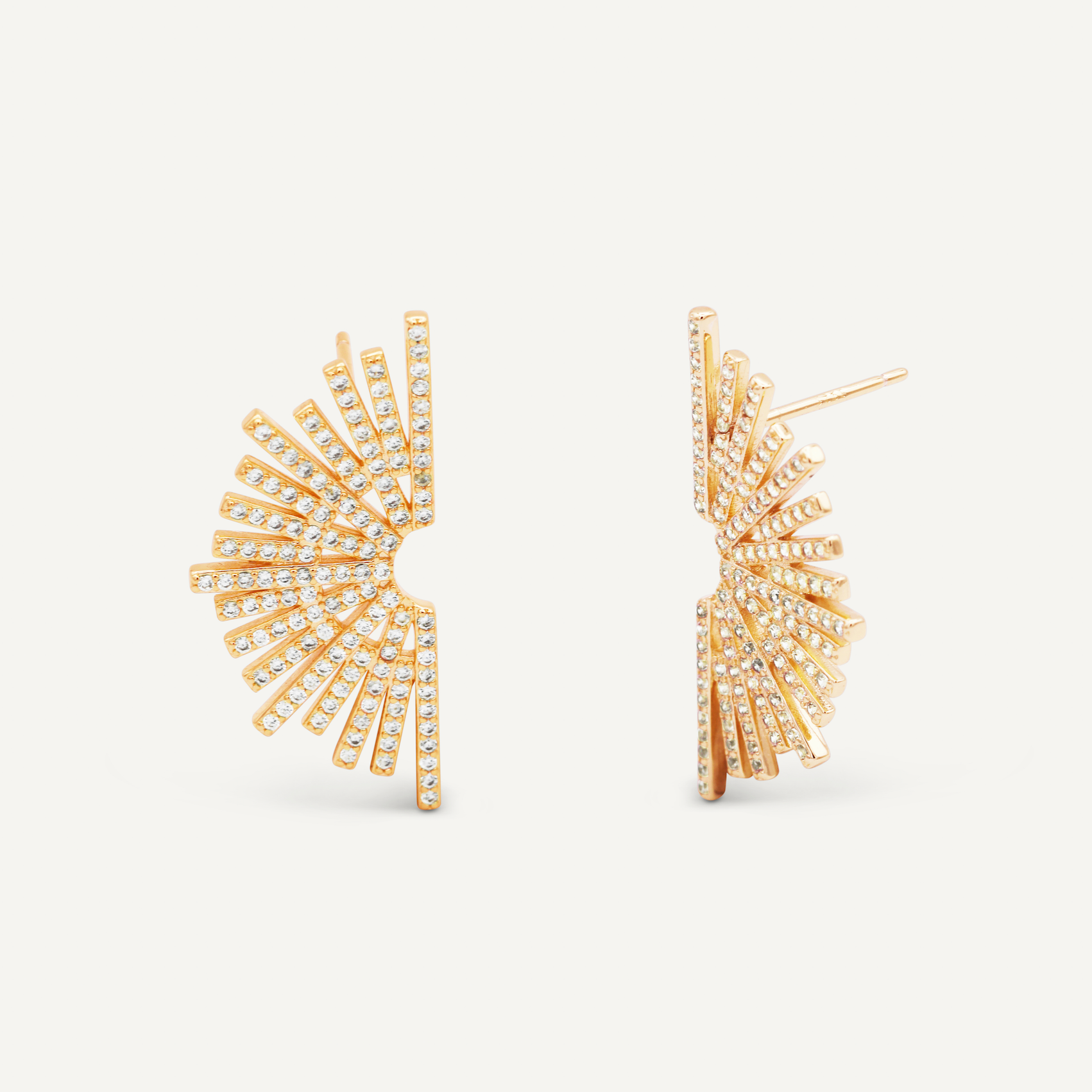 Sunburst Studs, gold vermeil earrings shaped like open fans and accented with rows of sparkling diamonds, are displayed from front and side angles on a plain white background.