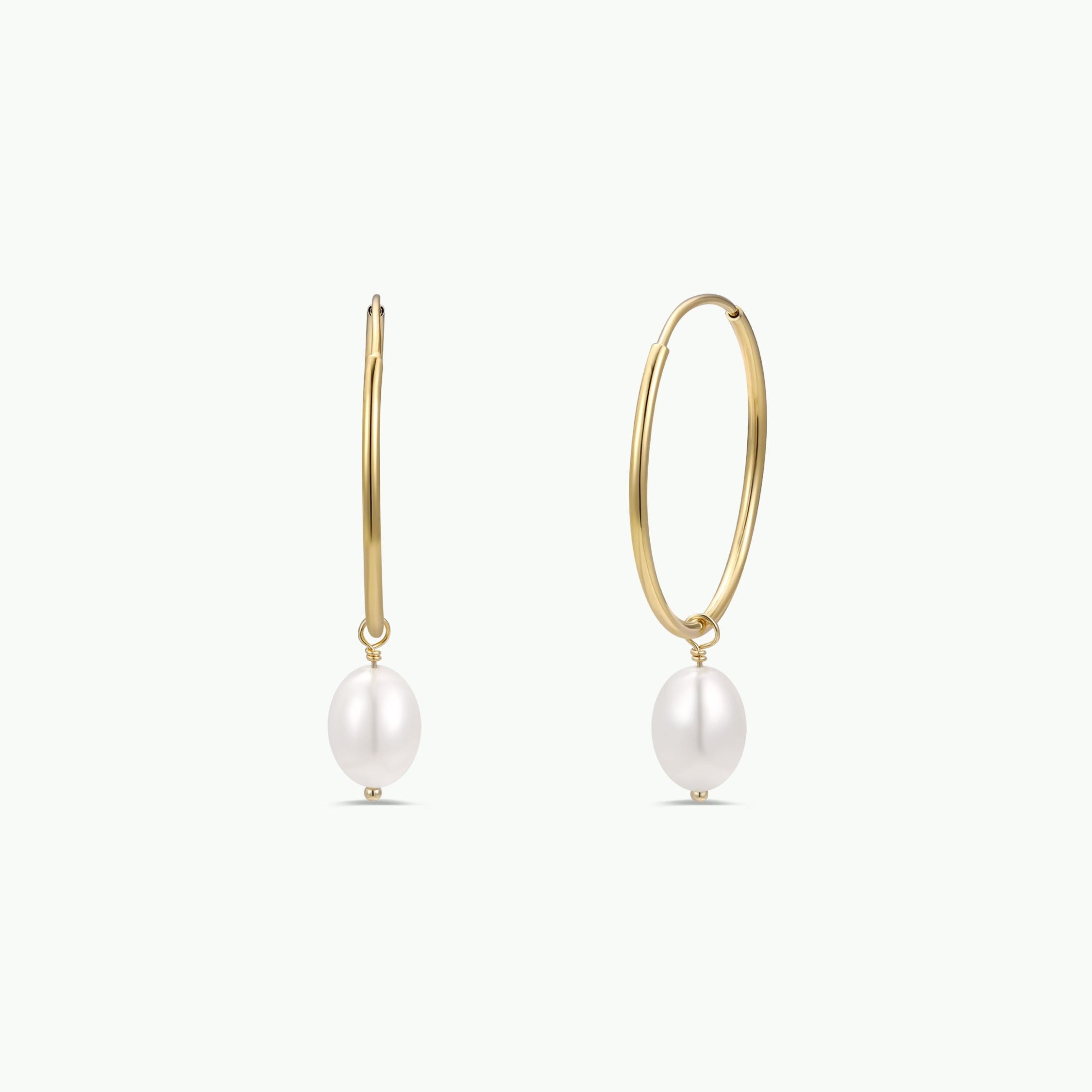 The Simple Hoop with Pearl features tarnish-free gold hoops, each with a single dangling white pearl, shown on a plain white background—an ideal pick for minimalist jewelry lovers.