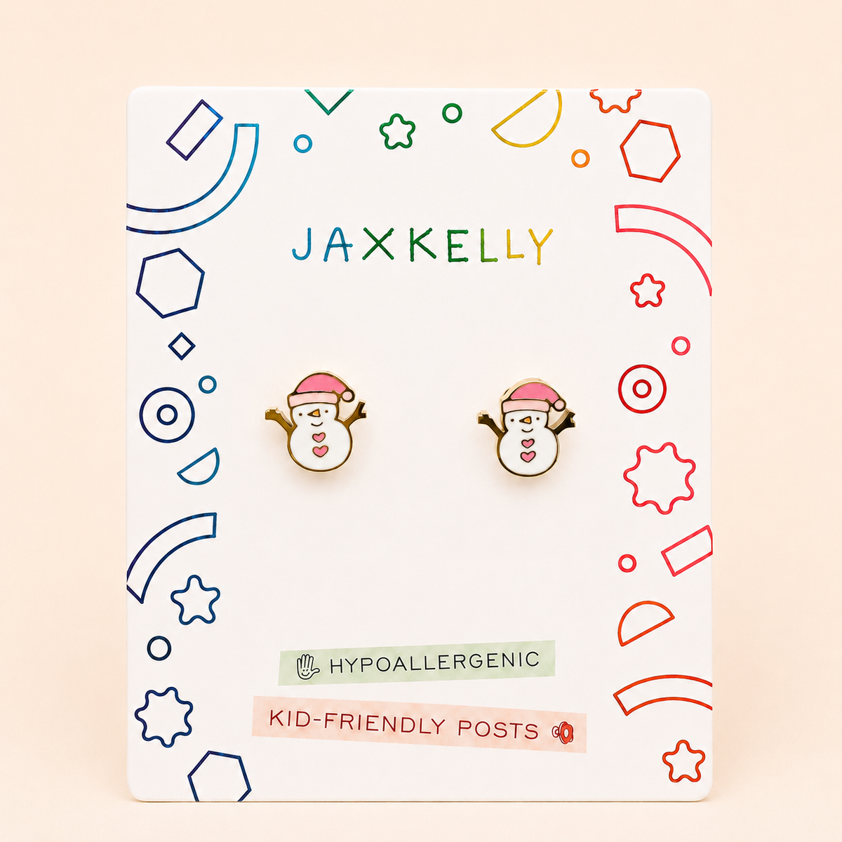 Snowman Enamel Flat Back Kids Earrings by JaxKelly, featuring snowman shapes with pink hats, displayed on a white JaxKelly card with colorful geometric designs and text that reads HYPOALLERGENIC and KID-FRIENDLY POSTS.