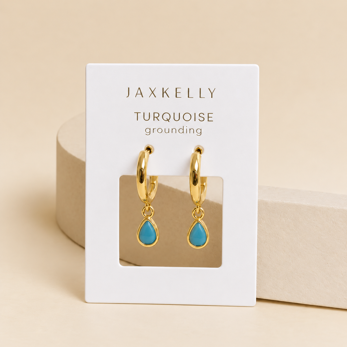 JaxKelly Teardrop Charm Hoop - Turquoise earrings on a display card, designed as hypoallergenic gold hoops.