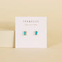 The Turquoise Baguette features small rectangular turquoise stud earrings with gold-plated settings and sterling silver posts, displayed on a white JaxKelly card against a beige background.