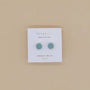 Round Amazonite Gemstone Gold Earrings by JaxKelly, displayed on a white card labeled "Wear Good Vibes" and "Amazonite Hope," shown against a beige background—minimalist studs perfect for any style.