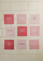 Nine Self-Love Shower Affirmations™ cards in pink, each waterproof and reusable, display unique self-love quotes in bold white text. The motivational cards are arranged in a 3x3 grid on a white tiled wall.