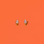A pair of hypoallergenic Ice Cream Enamel Flat Back Kids Earrings featuring white swirled soft serve and sprinkles, shaped like ice cream cones, set against a solid orange background.