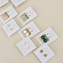 JaxKelly Round Amazonite Gemstone Gold Earrings, featuring minimalist style in pink, green, and white tones, are displayed on white branded cards.