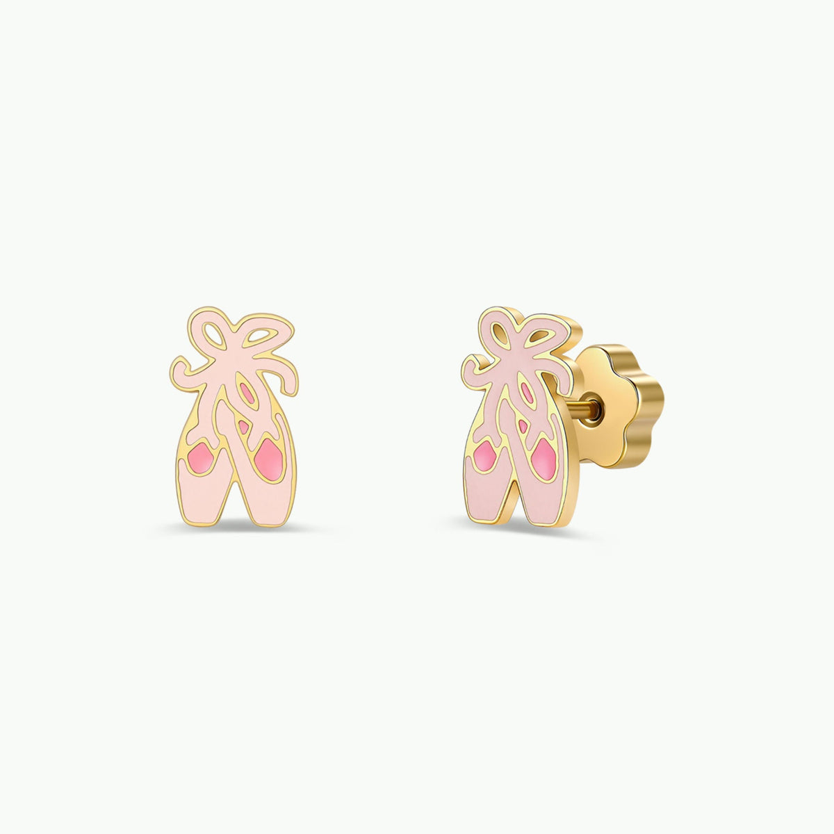 Introducing the Ballet Slippers Enamel Flat Back Kids Earrings by JaxKelly—a pair of gold earrings shaped like ballet slippers adorned with pink and light pink enamel accents and delicate bows at the top. Thoughtfully crafted as hypoallergenic earrings, they are gentle and safe for sensitive ears.