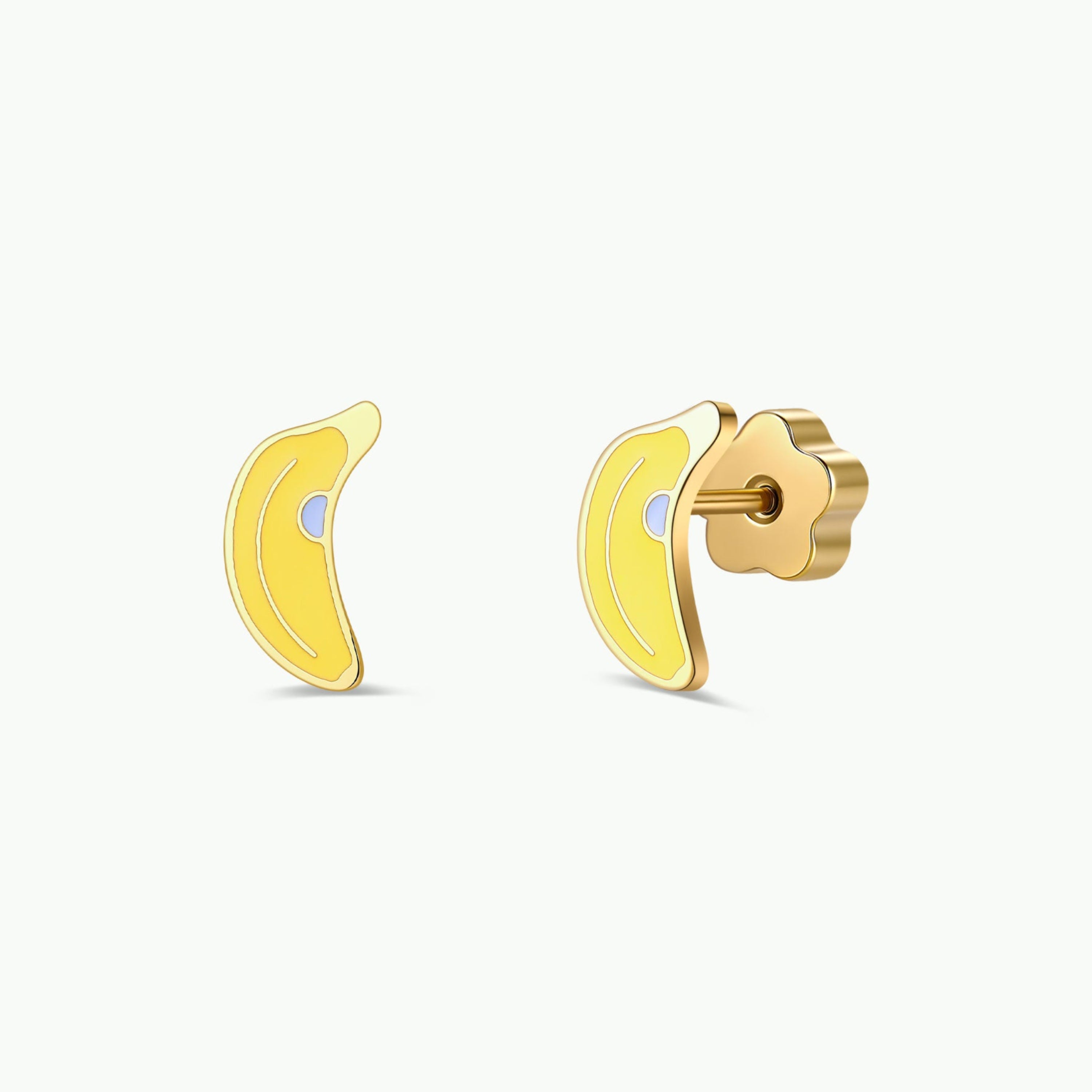 A pair of JaxKelly Banana Enamel Flat Back Kids Earrings, featuring a small gold and yellow banana-shaped design, perfect for sensitive ears, shown with one earring displayed from the front and the other from the side against a plain white background.
