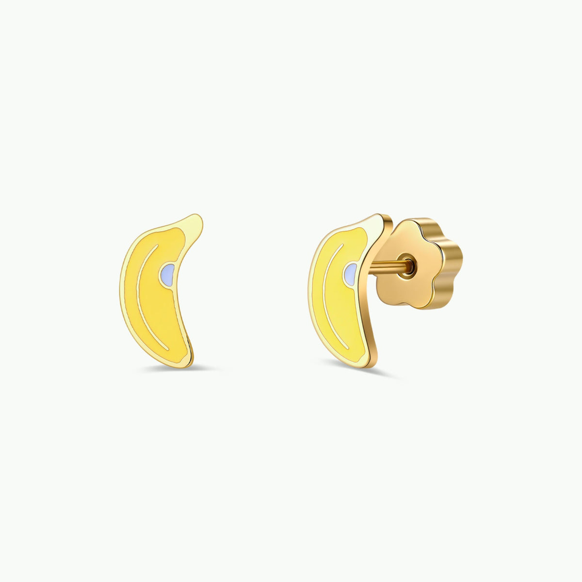 A pair of JaxKelly Banana Enamel Flat Back Kids Earrings, featuring a small gold and yellow banana-shaped design, perfect for sensitive ears, shown with one earring displayed from the front and the other from the side against a plain white background.