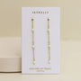JaxKelly's Gemstone Chain Drop - Mother of Pearl earrings feature small white beads and 18k gold plating, displayed on a white card with "Mother of Pearl calming" in gold, set against a neutral background.