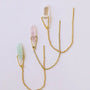 The JaxKelly Gemstone Threader - Rose Quartz, a minimalist gold earring with a pointed rose quartz crystal, is beautifully displayed on a white background—ideal for lovers of delicate jewelry.