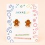 A pair of JaxKelly Gingerbread Man Enamel Flat Back Kids Earrings are displayed on a card with colorful geometric designs, labeled surgical-grade stainless steel hypoallergenic earrings with kid-friendly posts.