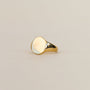 The Gold Signet Ring features a smooth, oval-shaped face with 18k gold plating and is displayed against a neutral background—an ideal accessory for everyday wear.