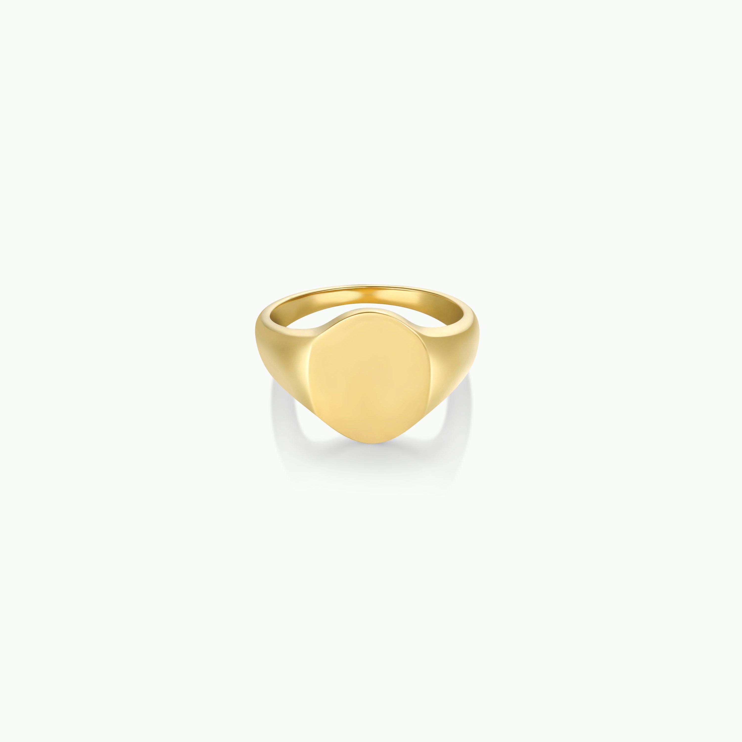 The Gold Signet Ring features 18k gold plating and a smooth, round flat face, elegantly displayed against a plain white background—ideal for everyday wear.