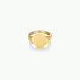 The Gold Signet Ring features 18k gold plating and a smooth, round flat face, elegantly displayed against a plain white background—ideal for everyday wear.