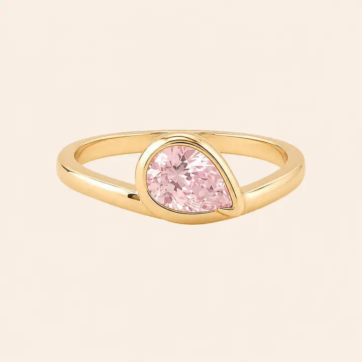 Halo Drop Gold Ring - Pink CZ featuring a pear-shaped pink crystal set in a gold bezel.