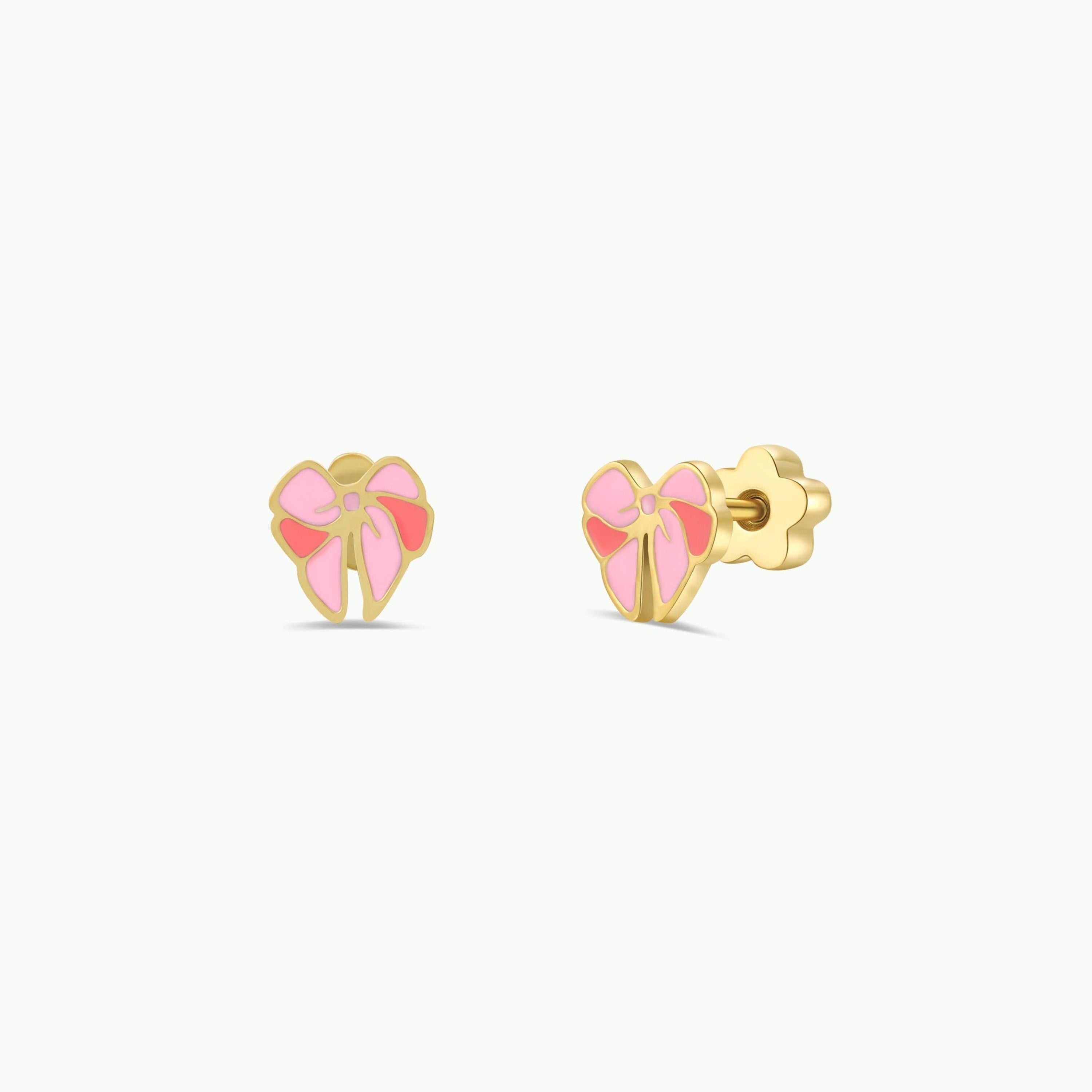 The Bow Enamel Flat Back Kids Earrings are small gold studs shaped like bows with pink enamel accents and a screw-back design, shown on a plain white background.