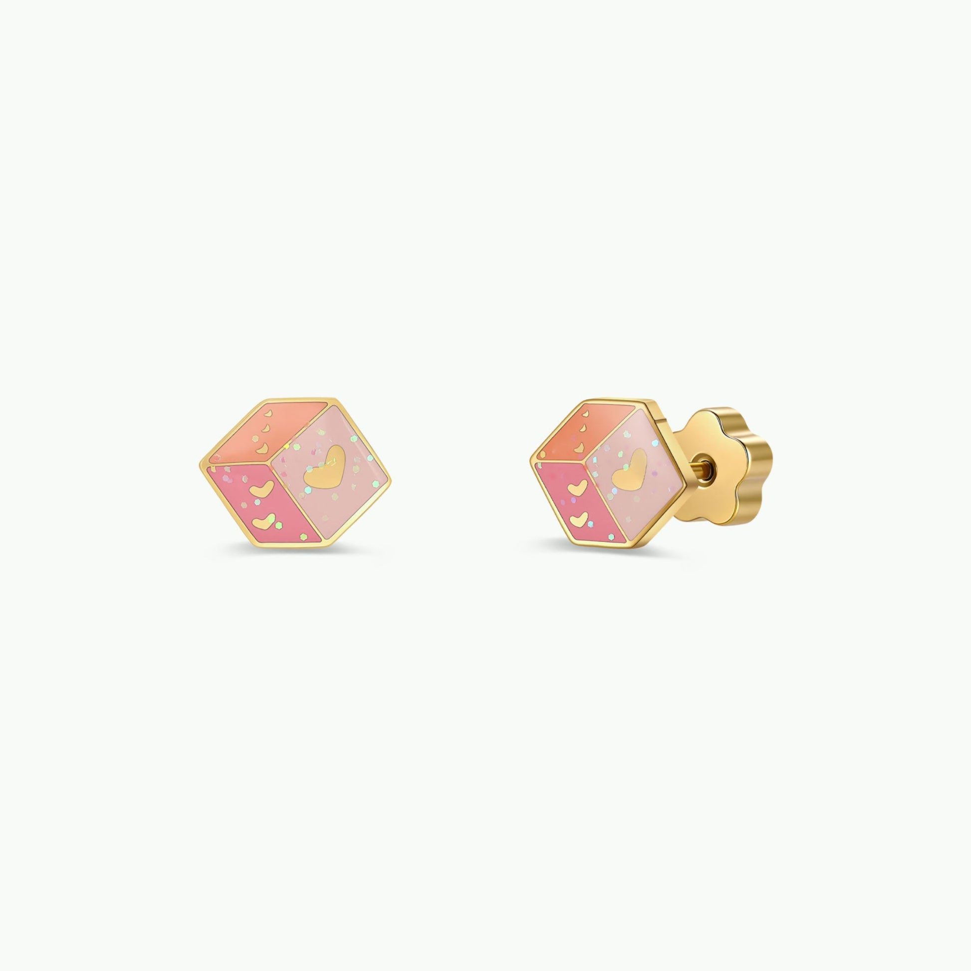Pair of Pink Dice Enamel Flat Back Kids Earrings by JaxKelly, featuring hexagonal gold designs adorned with pink enamel, small yellow dots, and a yellow heart at the center. Displayed on a white background, these hypoallergenic earrings are perfect for sensitive ears, providing comfort and style all day long.