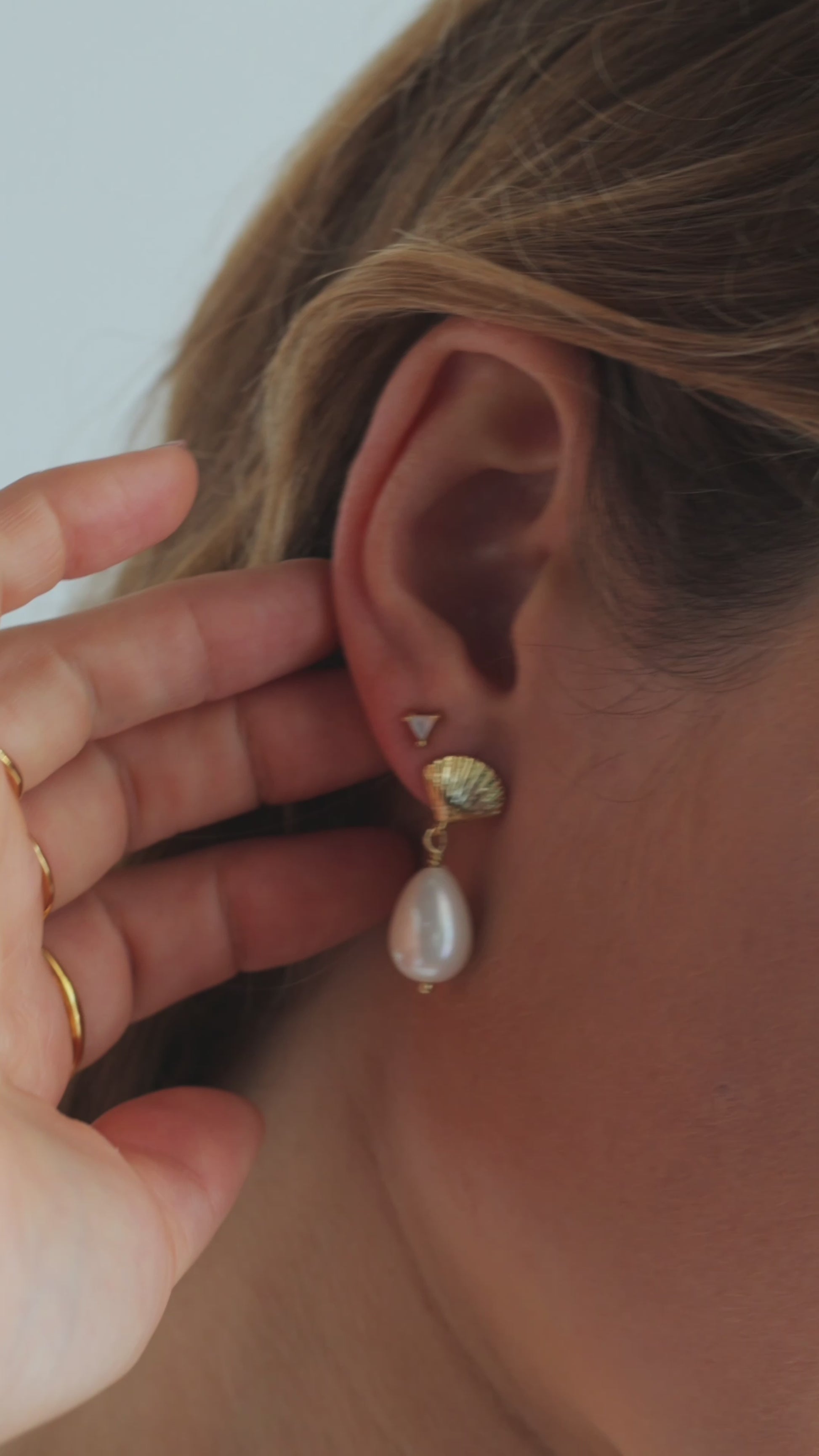 JaxKelly's White Opal Mini Energy Gems and other JaxKelly jewelry styles on a model.