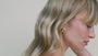 JaxKelly's Gold Bold Wave earrings on a model.