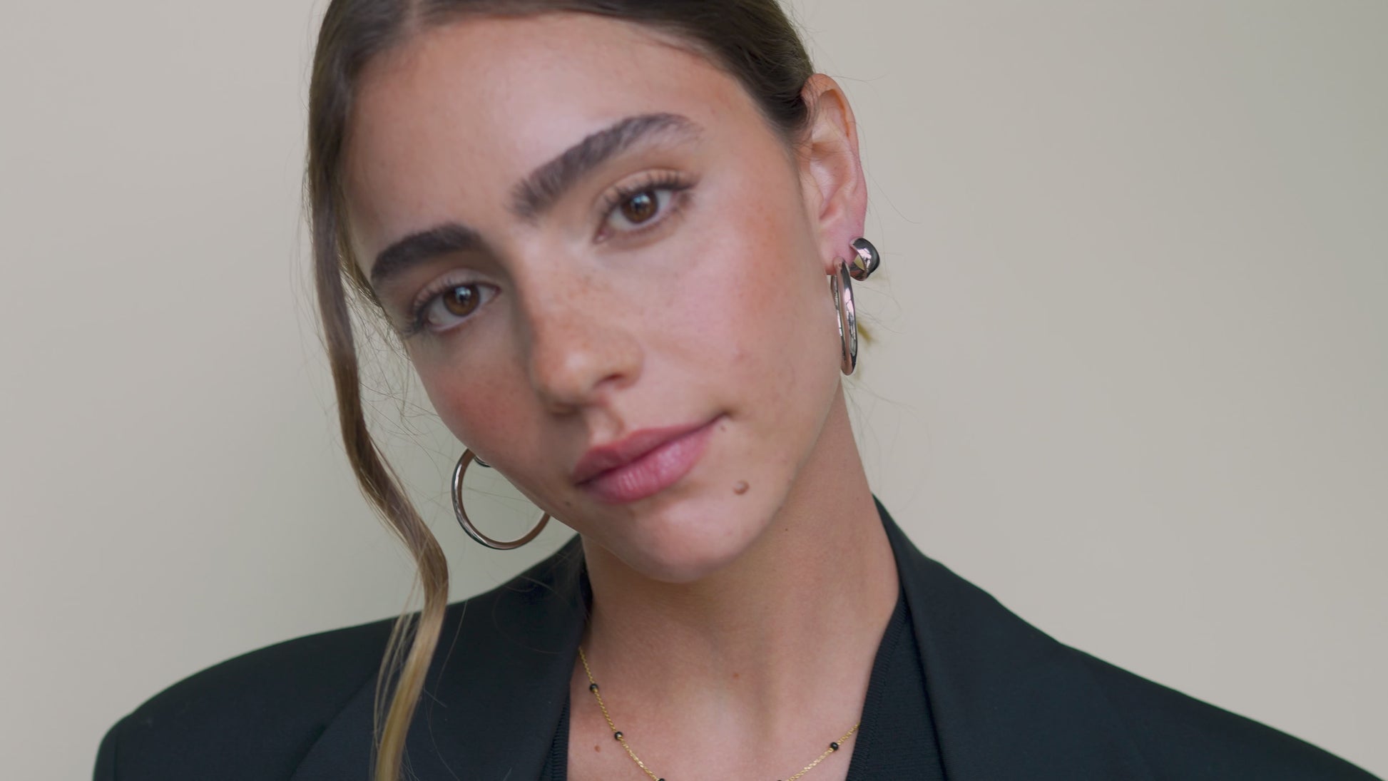 JaxKelly's Silver Wide Hoop Earrings on a model. 