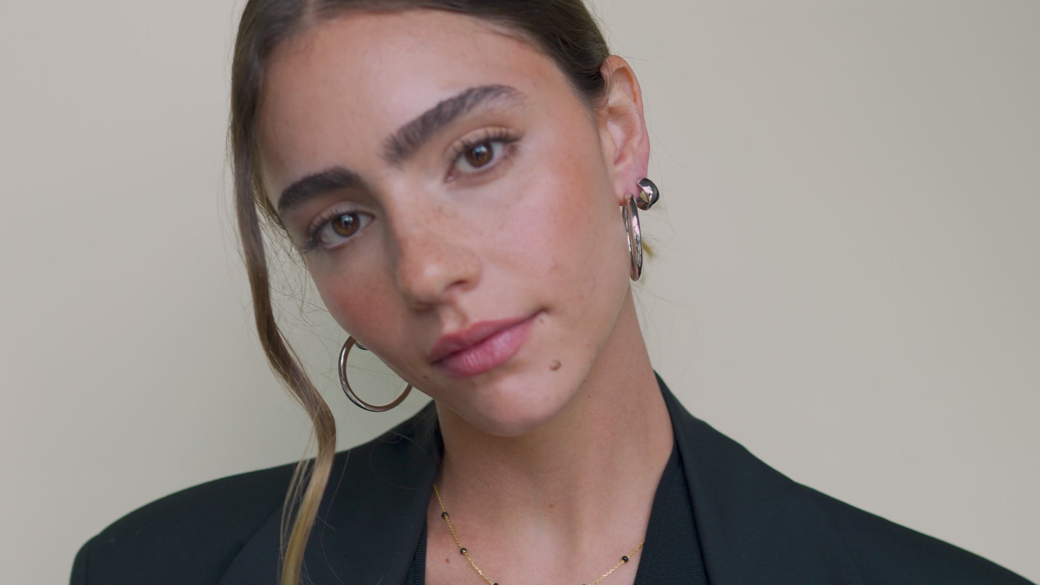 JaxKelly's Silver Wide Hoop Earrings on a model. 