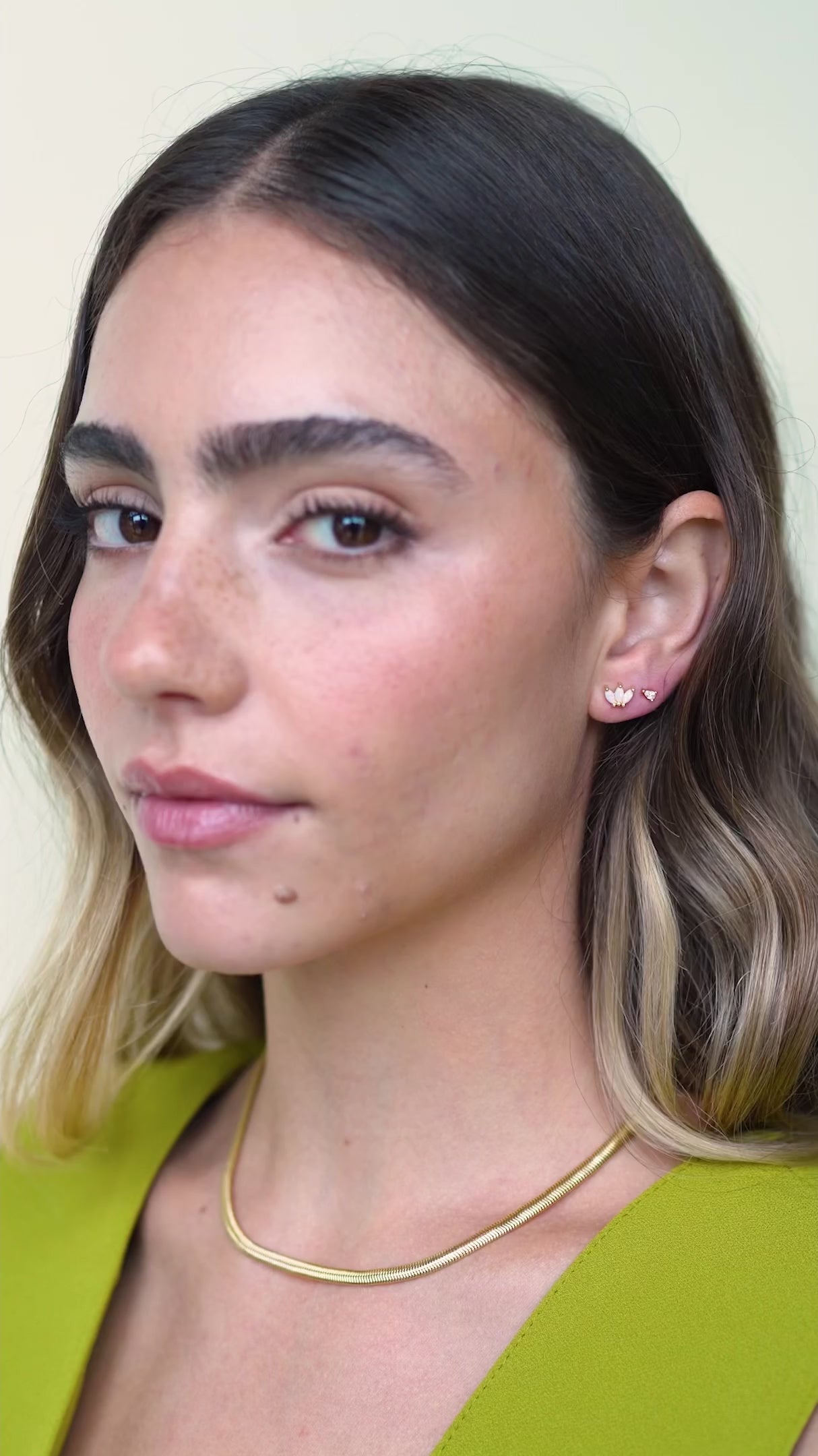 Decorative video showing JaxKelly's White Opal Crown Stud earrings on a model.