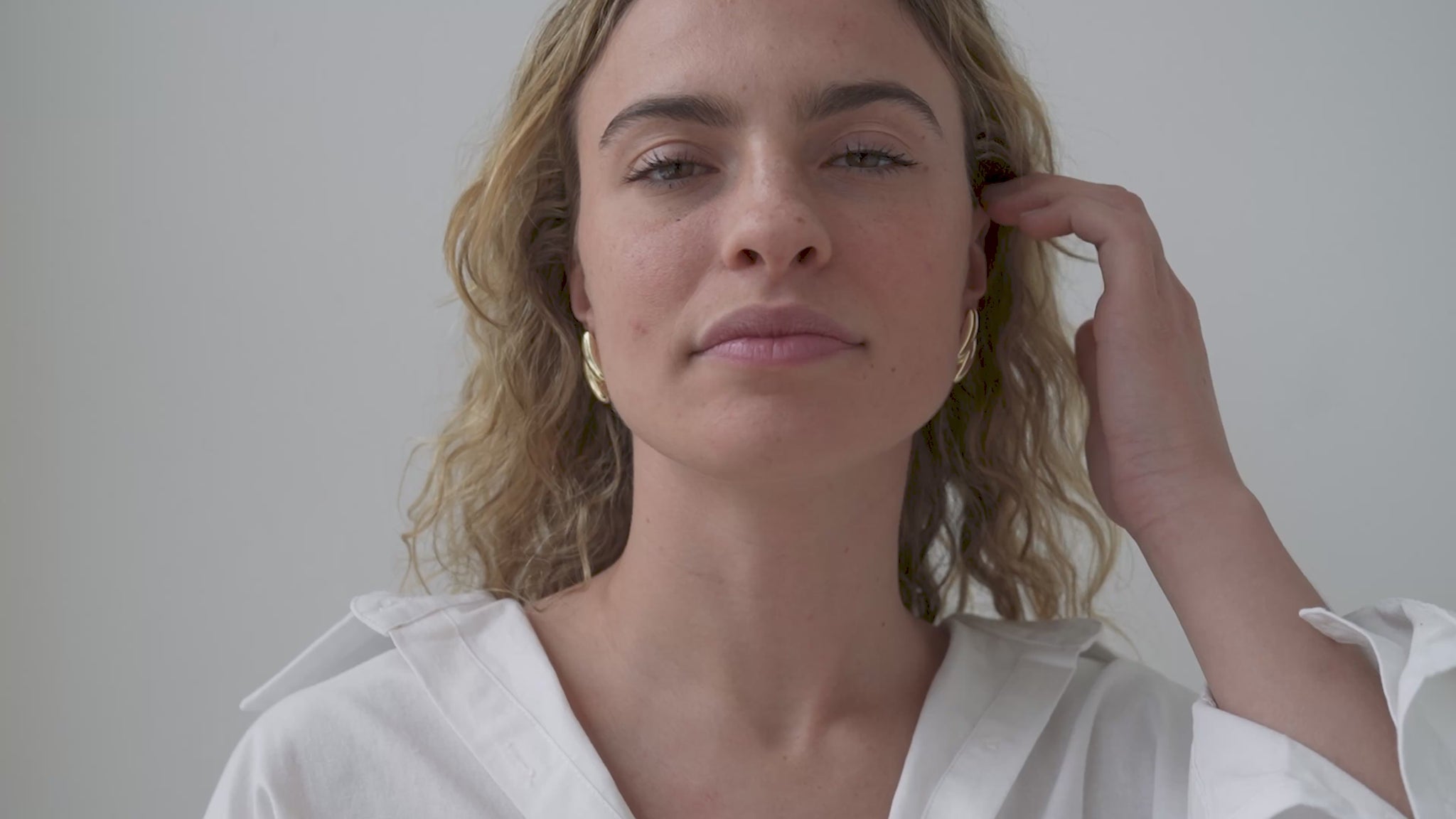 JaxKelly's Gold Double Bold Bar earrings on a model.