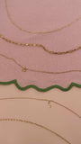 JaxKelly's Small Link Necklace and other JaxKelly necklace styles on a pink fabric backdrop with green trim.