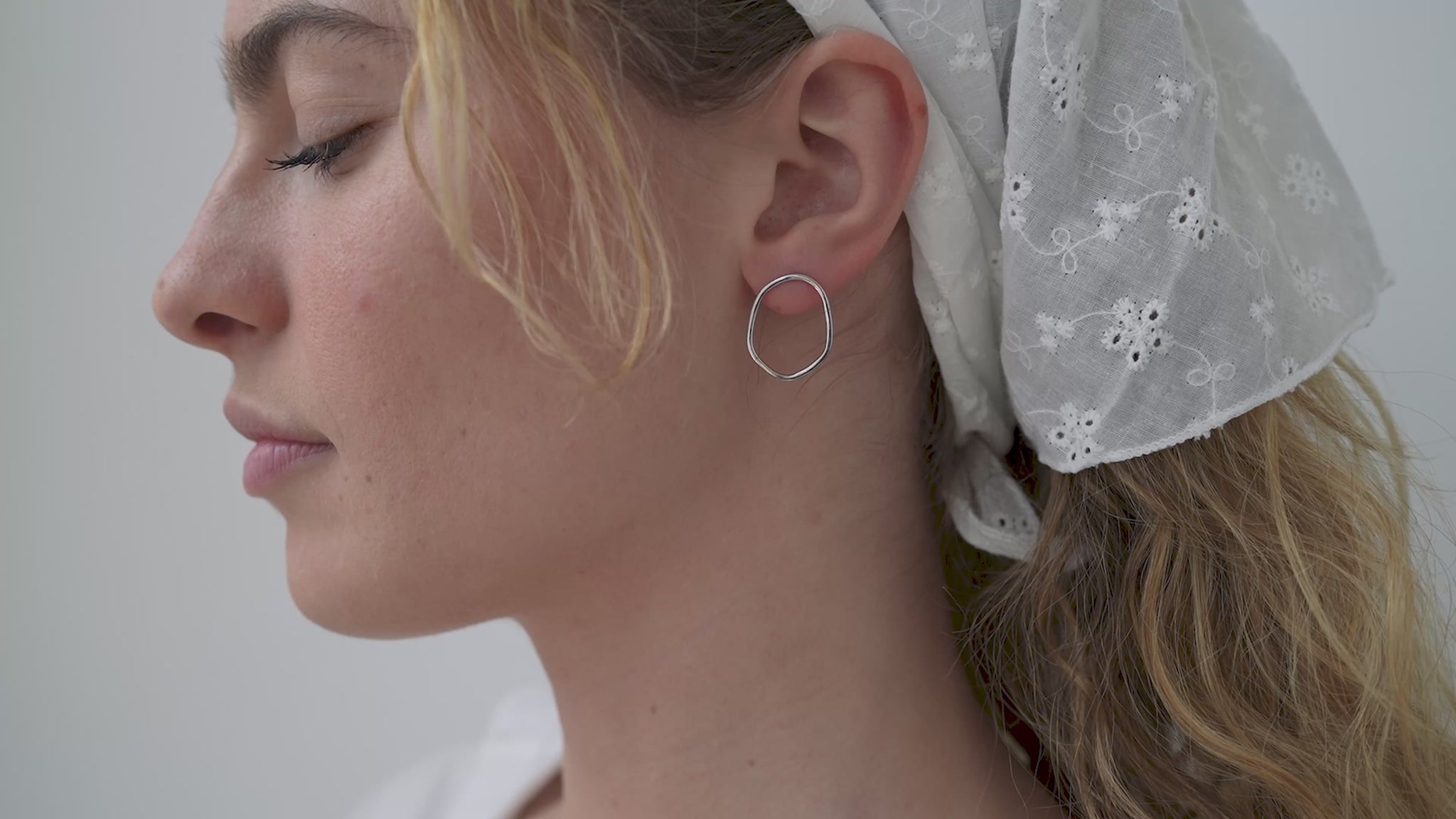 JaxKelly's Silver Organic Hoops on a model.