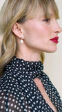 JaxKelly's Seashell Pearl Drop earrings on a model.