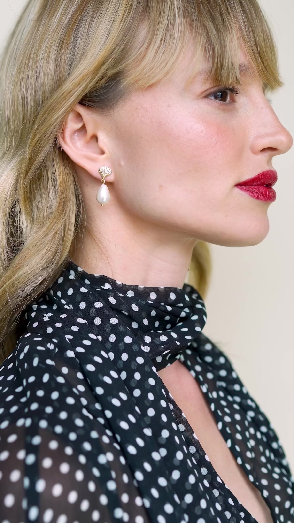 JaxKelly's Seashell Pearl Drop earrings on a model.