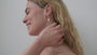 JaxKelly's Heart Drop earrings with Mother of Pearl on a model.