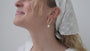 JaxKelly's Oval Pearl Drop earrings on a model.