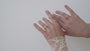 JaxKelly's Champagne Pave Wave Ring and other JaxKelly ring styles on a model's hand.