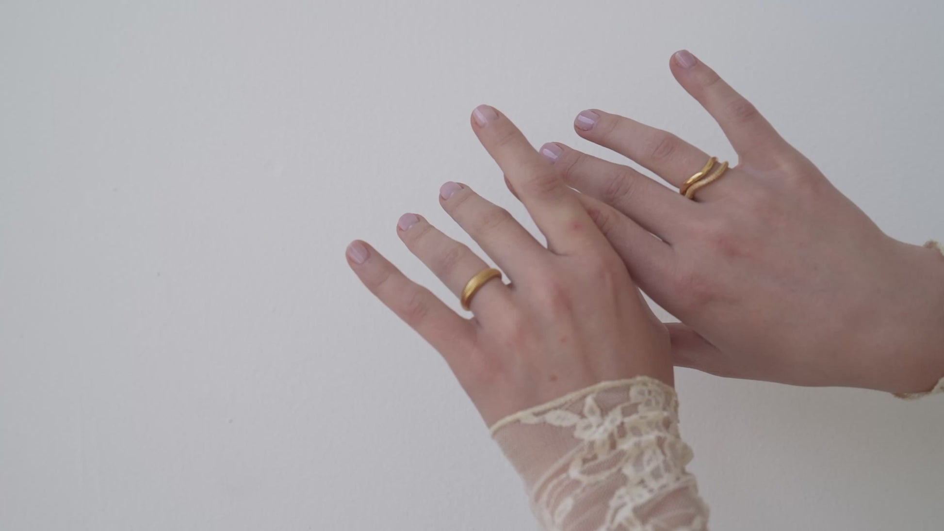 JaxKelly's Champagne Pave Wave Ring and other JaxKelly ring styles on a model's hand.