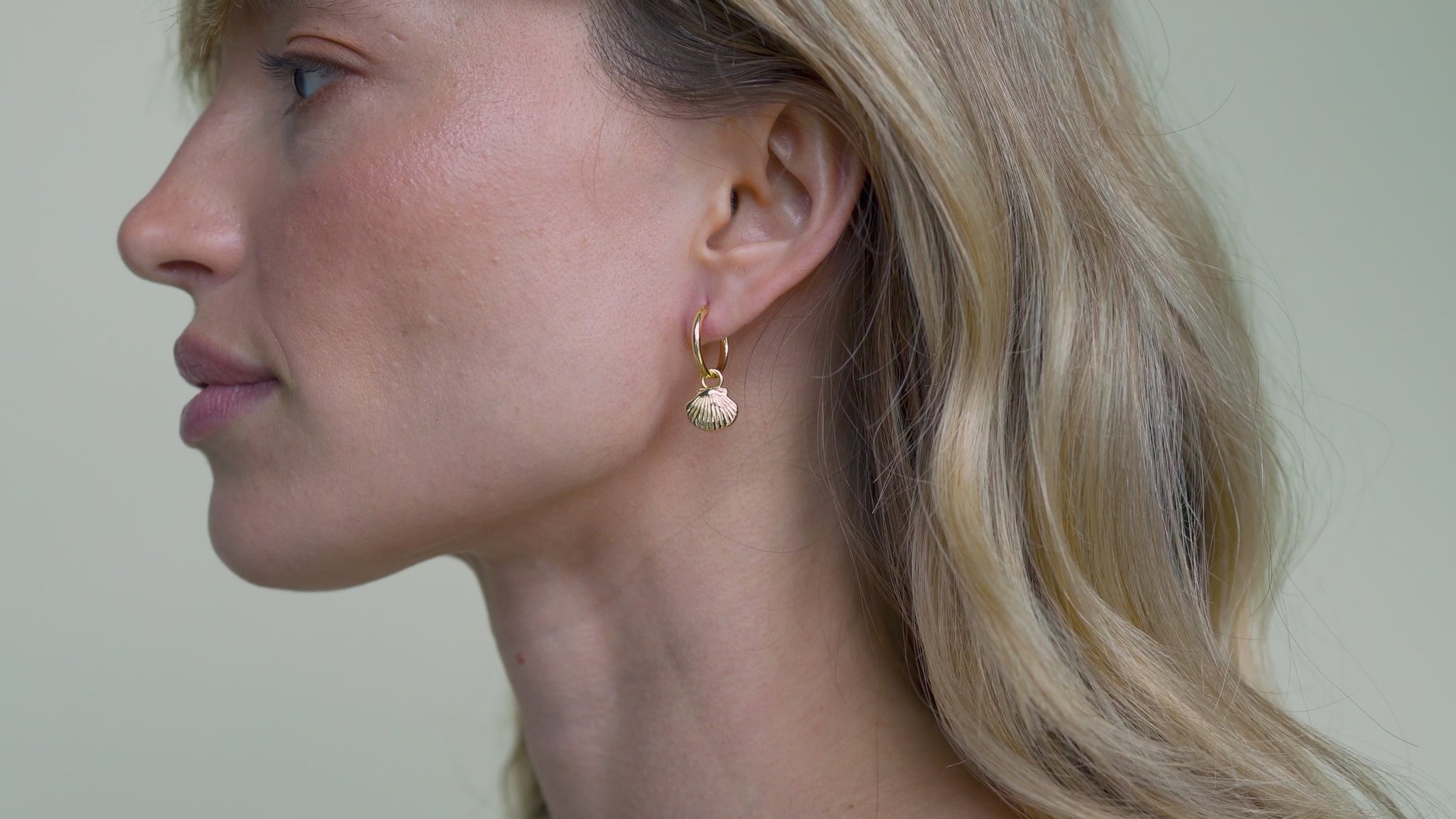 JaxKelly's Seashell Hoop earrings on a model.