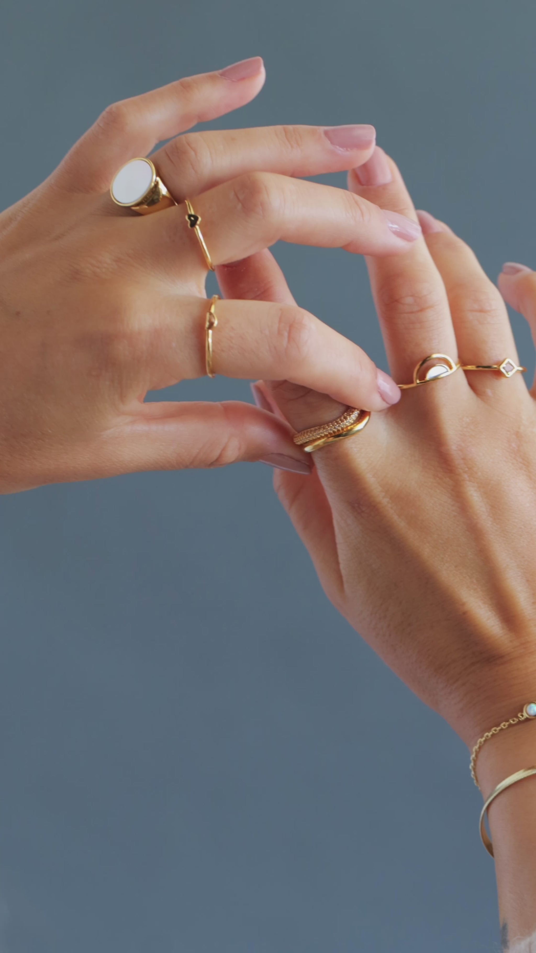 JaxKelly's Half Moon Champagne Ring and other JaKelly ring styles displayed on a model's hands.
