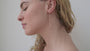 JaxKelly's Raw Gemstone Chain Drop earrings in Rose Quartz on a model.