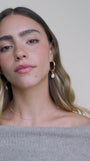 Decorative video showing JaxKelly's Twisted Pearl Drop Hoop earrings on a model.