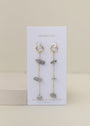 Raw Gemstone Chain Drop Earring - Rainbow Moonstone: Gold chain drop earrings with dangling chains and irregular rainbow moonstone beads, displayed on a white JaxKelly card marked "RAINBOW MOONSTONE peace." Tarnish free for effortless style.